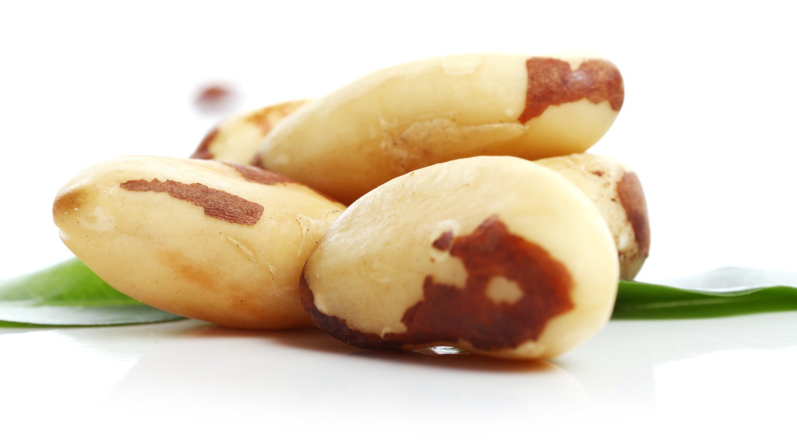Close up of fresh brazil nuts against white background