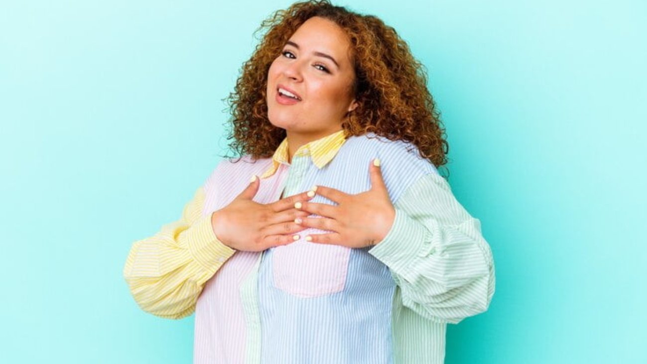 young-latin-curvy-woman-isolated-blue-wall-has-friendly-expression-pressing-palm-chest-love-concept_1187-143515
