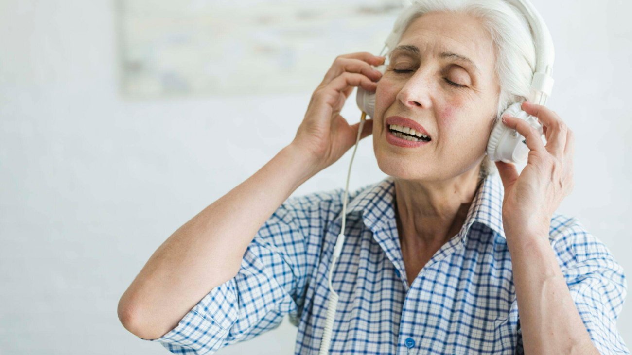 senior-woman-listening-music-headphone