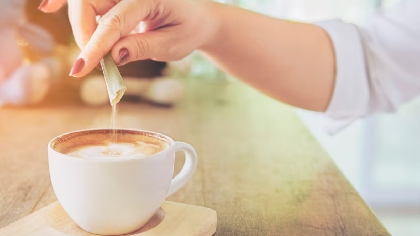 closeup-lady-pouring-sugar-while-preparing-hot-coffee-cup_1150-6487-jpg-740×493-