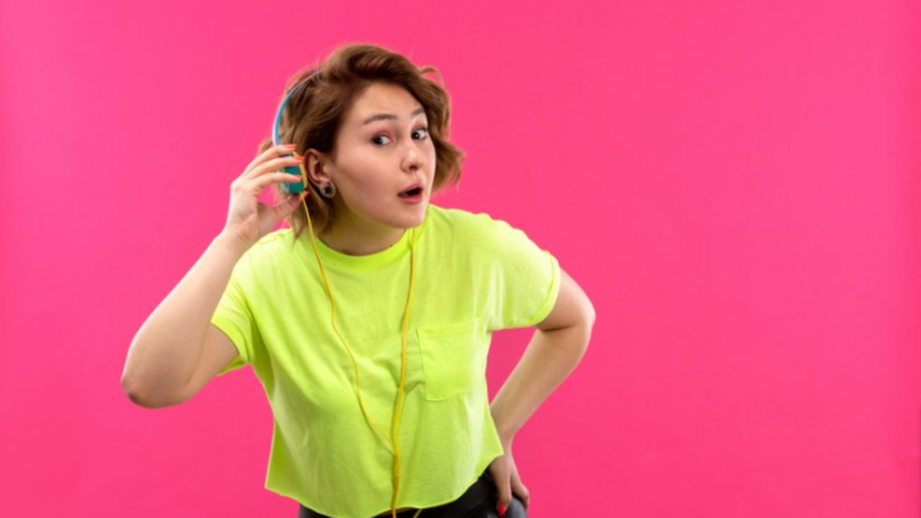 Free-Photo-A-front-view-young-beautiful-lady-in-acid-colored-shirt-black-trousers-with-blue-earphones-listening-to-music-trying-to-hear