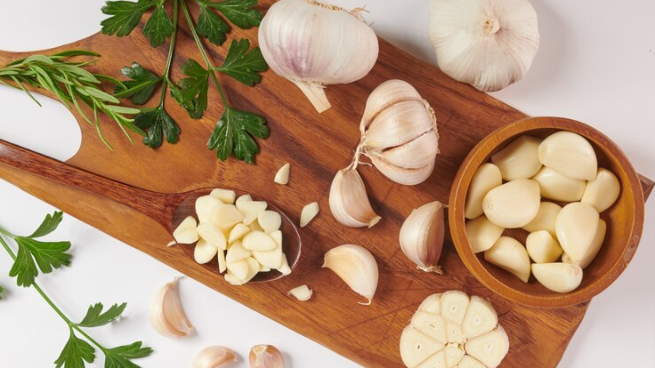 garlic-with-rosemary-parsley-peppercorn-wooden-board-isolated-white-surface-top-view-flat-lay-freshly-picked-from-home-growth-organic-garden-food-concept-