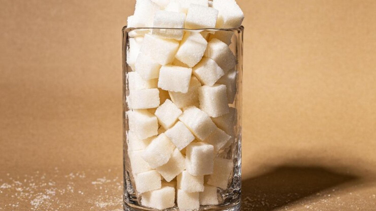 sugar-consumption-addiction-concept-refined-cubes-sweet-lumps-glass-sugary-food