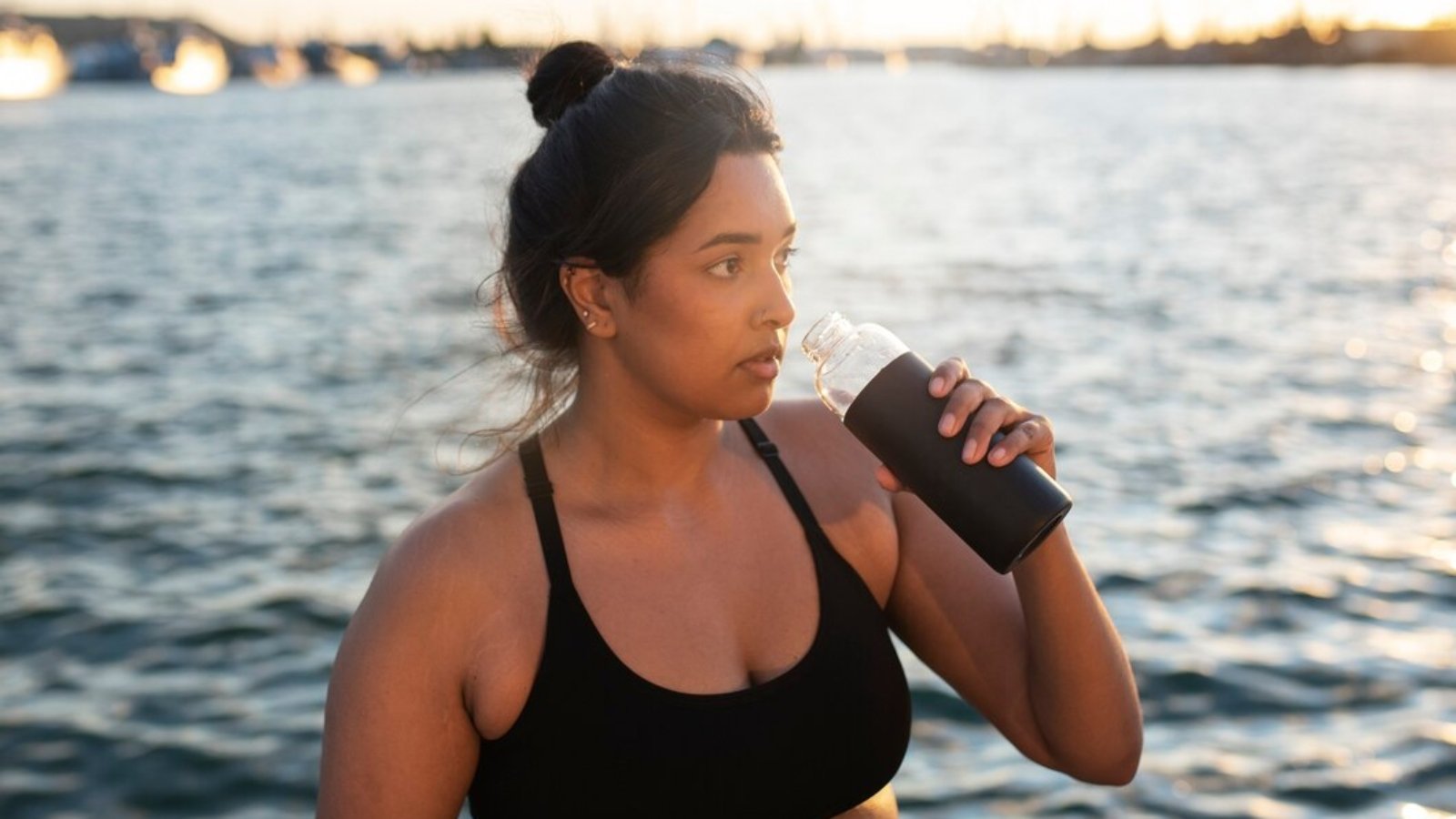 overweight-woman-getting-hydrated-with-water-after-exercising-outdoors_23-2149618247