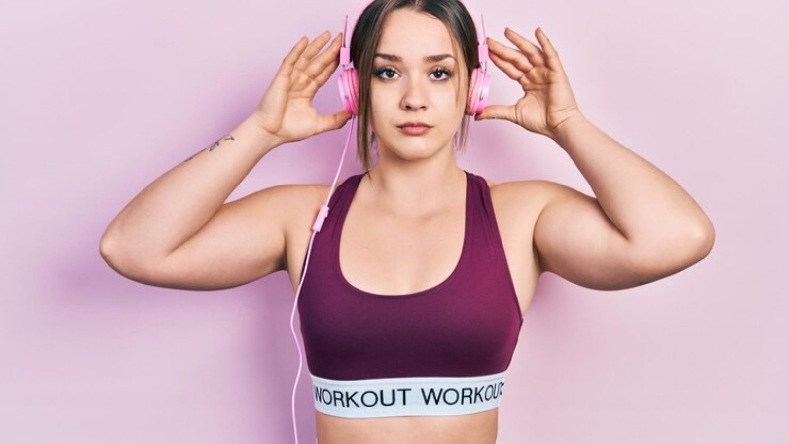 young-hispanic-girl-wearing-gym-clothes-using-headphones-relaxed-with-serious-expression-face-simple-natural-looking-camera_839833-25195