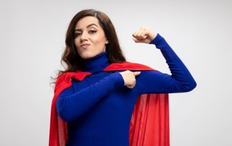 confident-caucasian-superhero-girl-with-red-cape-tenses-points-biceps-white_141793-98028